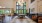a large room with a chandelier and  a long table with chairs