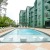 swimming pool with lounge chairs next to a building