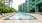 swimming pool with lounge chairs next to a building